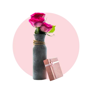 Beautiful gift box beside a vase of pink roses, perfect for gifting and celebrations in Melbourne.