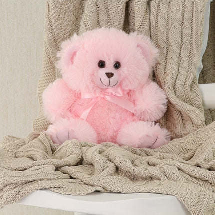 Baby Teddy – Pink Plush Bear with satin ribbon on a cozy blanket.