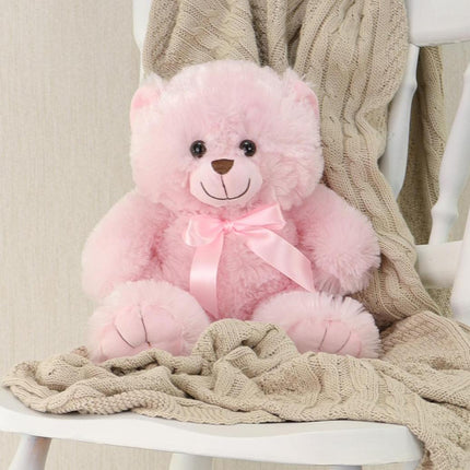 Pink Cuddle – Baby Teddy Bear with satin ribbon on a cozy blanket.