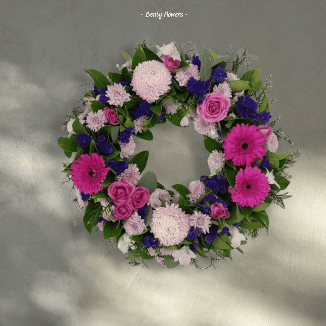 Graceful Wreath arrangement featuring soft pinks and whites, perfect for elegant funeral tributes.