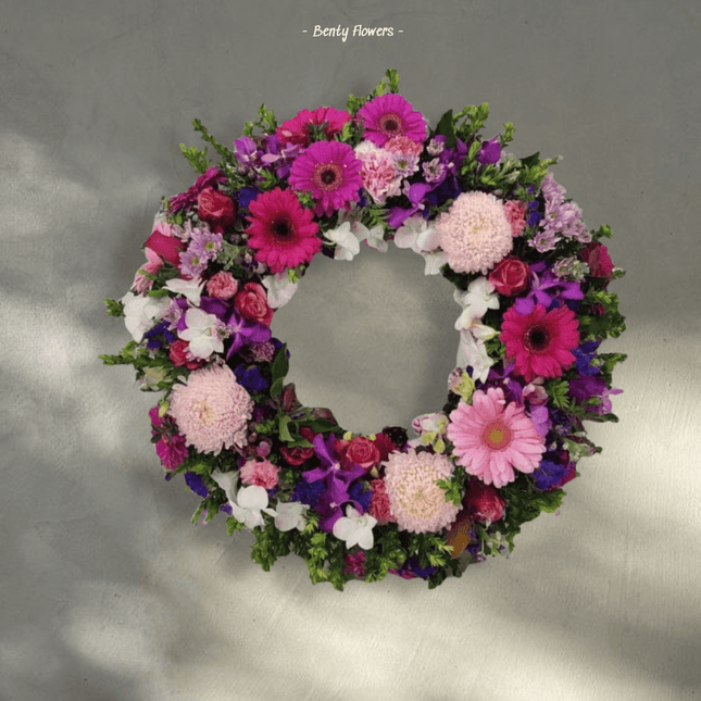 Elegant pink floral wreath, perfect for funerals, representing love and remembrance in Melbourne.