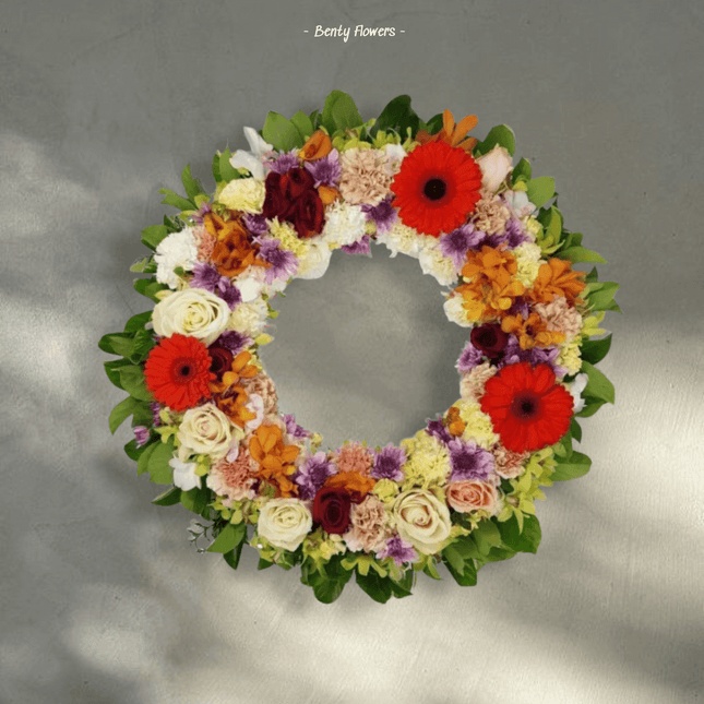 Radiant Harmony Wreath from Benty Flowers, a colorful floral tribute for funerals in Melbourne.