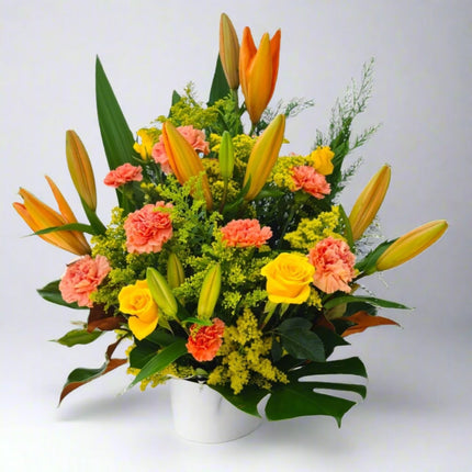 Blossom Radiance Bouquet – Featuring Orange Lilies, Peach Carnations, and Yellow Roses