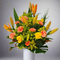Vibrant Peach Harmony flower arrangement featuring orange lilies, yellow roses, and pink carnations in a classic box.