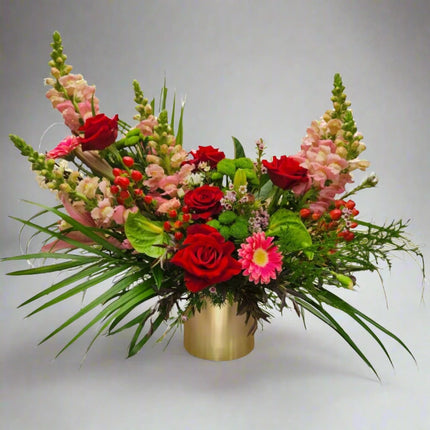 Vibrant Floral Arrangement with Red Roses, Pink Snapdragons, and Greenery in a Gold Vase