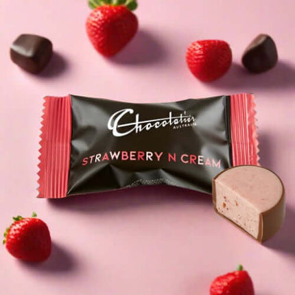Chocolatin Australia Strawberry N Cream chocolate surrounded by fresh strawberries and dark chocolates.