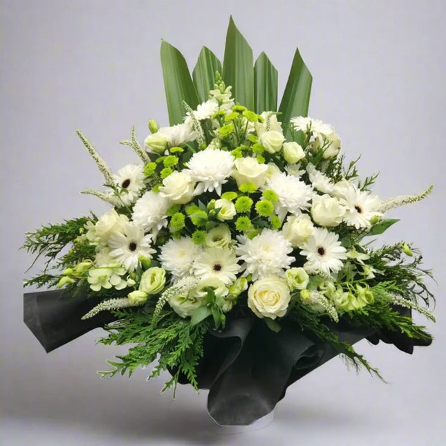 Peaceful Tribute funeral flowers arrangement in soft whites and greens, perfect for memorial services in Melbourne.