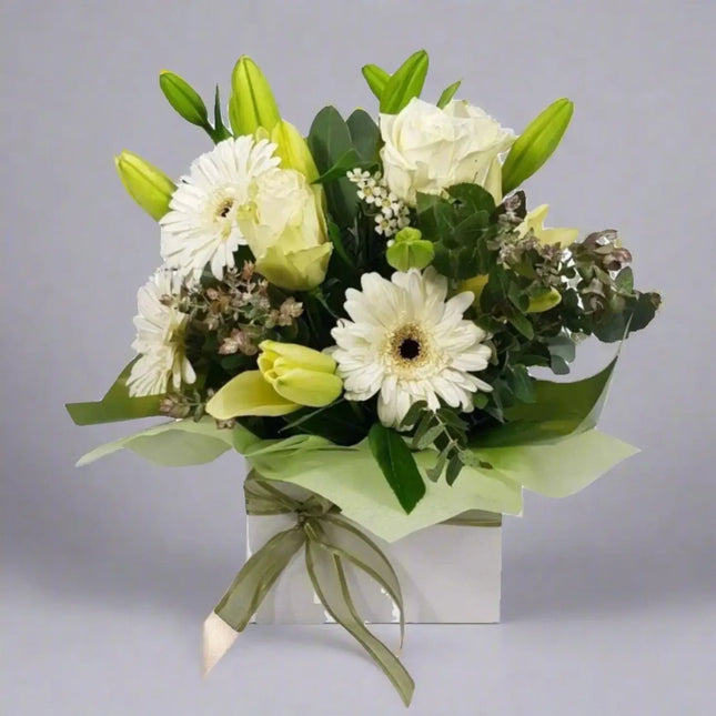 Serene white floral arrangement in elegant box, symbolizing sympathy and remembrance for funerals in Melbourne.