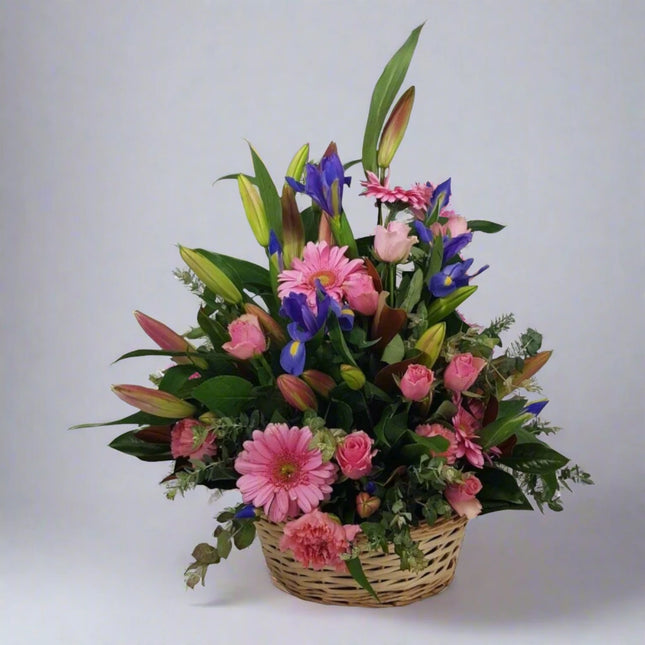 Blossom Delight – Pink and Purple Floral Basket with gerberas, lilies, irises, and roses.