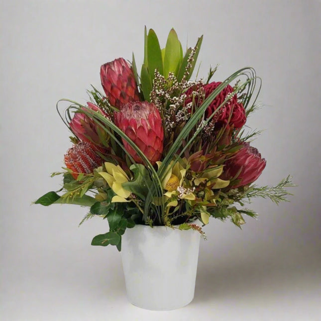 Rustic Charm – Native Floral Arrangement with protea, banksia, wax flowers, and leucadendron.