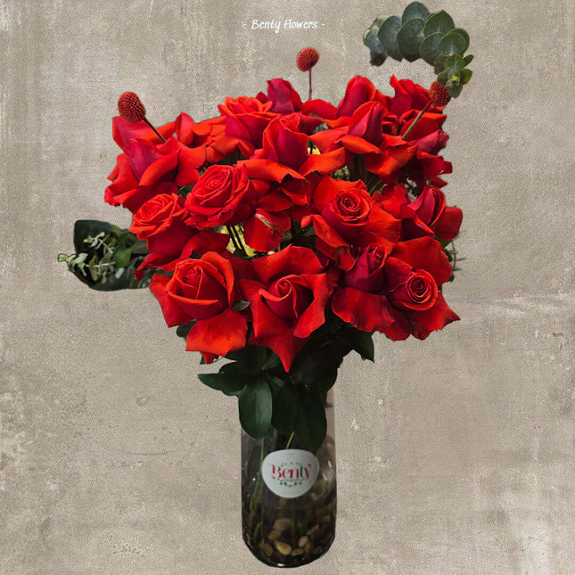 Lush red rose bouquet in a glass vase, perfect for romantic occasions in Melbourne.