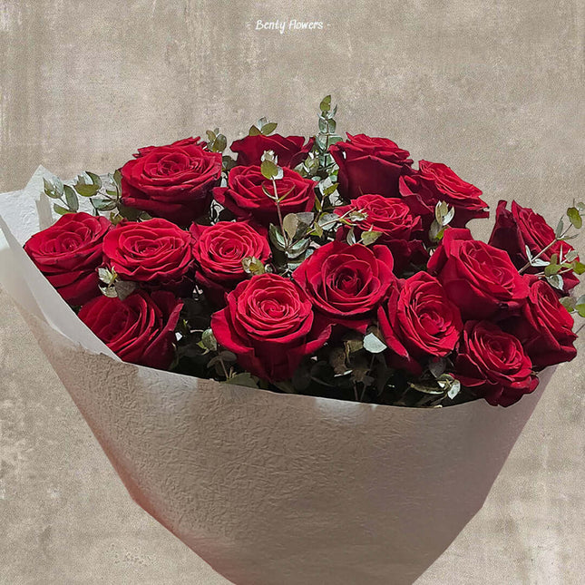 Bouquet of 18 romantic red roses in a matte vase, perfect for expressing love in Melbourne.