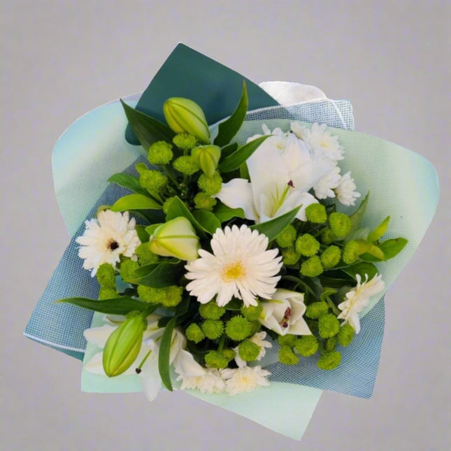 Fresh Harmony bouquet with white lilies, white gerberas, green button mums, and lush greenery