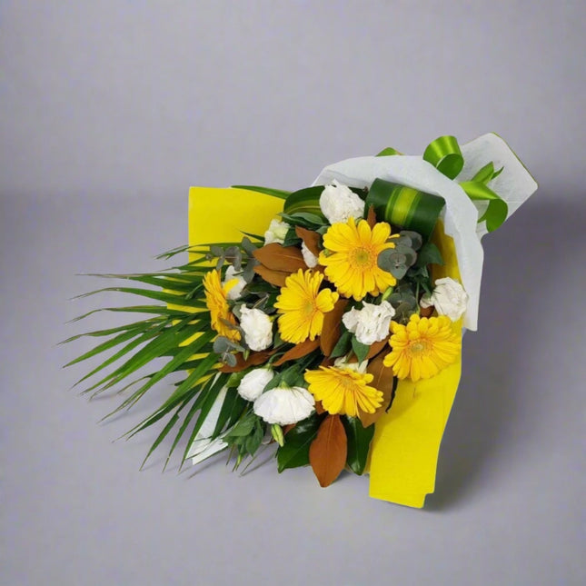 Sunshine Bouquet – Yellow and White Floral Wrap with yellow gerberas, white roses, and chrysanthemums.