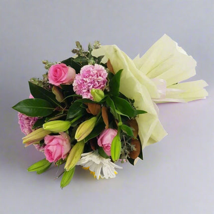 Sweet Harmony – Pink and White Bouquet with pink roses, white lilies, and carnations.