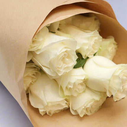 Pure Elegance – White Rose Bouquet wrapped in kraft paper. close up