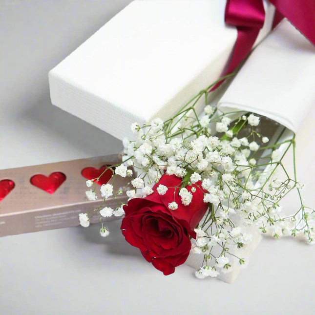 Romantic Gesture – Rose and Chocolate Gift Set with a red rose, baby's breath, and gourmet chocolates.