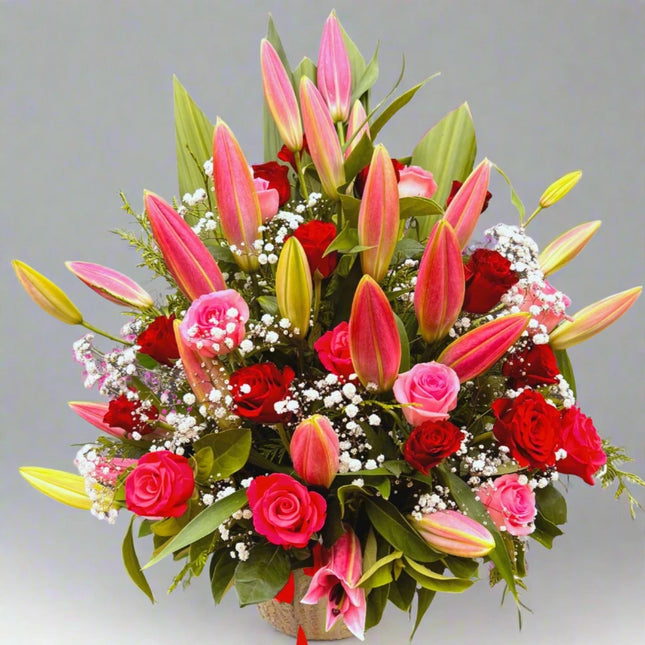 Romantic Radiance – Red and Pink Lily Bouquet with red roses, pink lilies, and baby's breath.