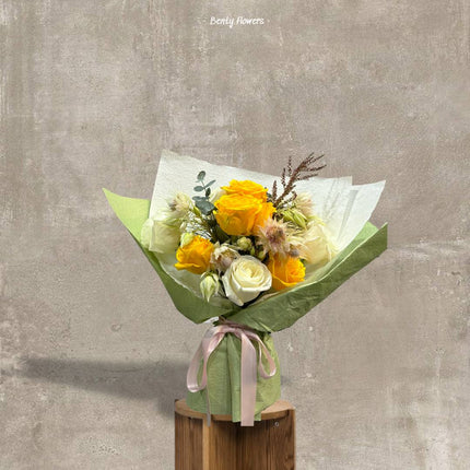 Vibrant yellow and white rose bouquet accented with soft pink blooms, elegantly arranged for special celebrations and thoughtful gifting.