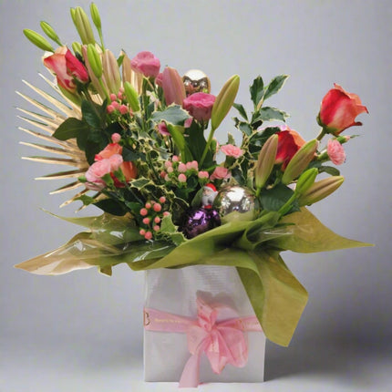 Holiday Cheer – Festive Floral Box with red roses, pink lilies, hypericum berries, and golden accents.