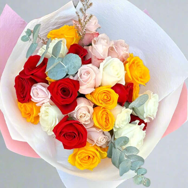 Elegant bouquet of red, yellow, white, and peach roses with greenery, embodying romance and passion.