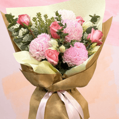 Beautiful bouquet of pink roses and chrysanthemums wrapped for birthday and anniversary celebrations.