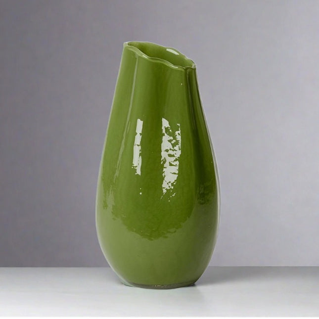 Natalie Vase Green 40cm in a glossy green color on a gray background.