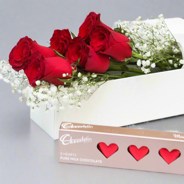 Romantic Rose and Chocolate Gift Box featuring red roses, baby’s breath, and gourmet heart-shaped chocolates. Perfect for Valentine's Day and anniversaries.